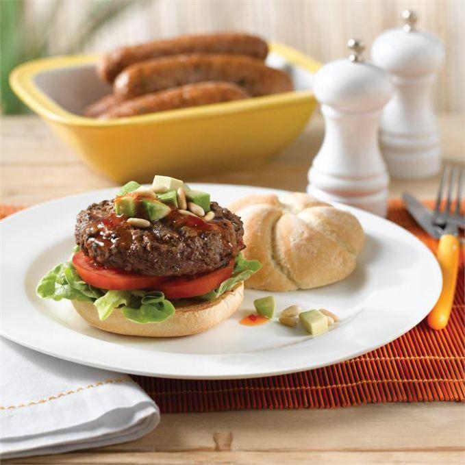 Beef burgers with a topping of avocado, sweet chilli sauce and toasted ...